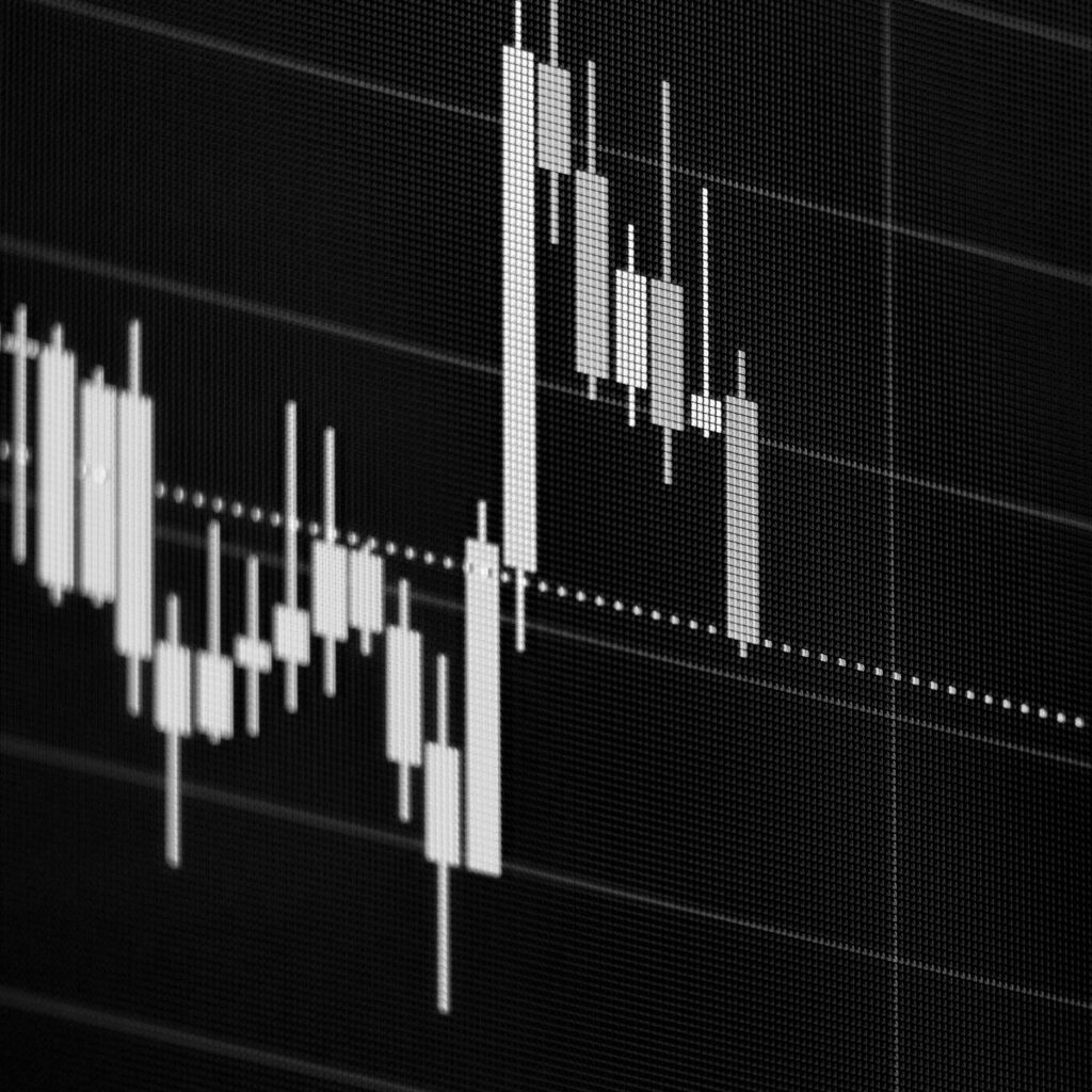 Close-up of a digital candlestick chart showing financial market fluctuations, illustrating investment performance and stock trading analysis.